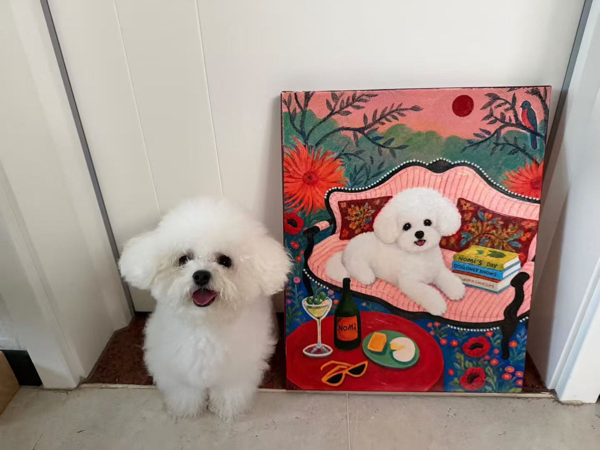 White fluffy dog sitting beside a colorful custom portrait of the same dog on a pink sofa.